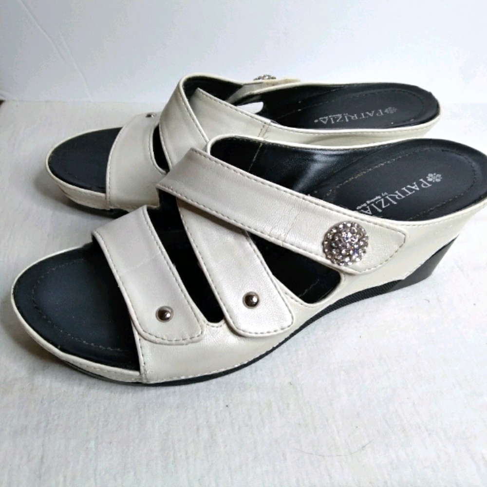 Patrizia white slip on sandals.